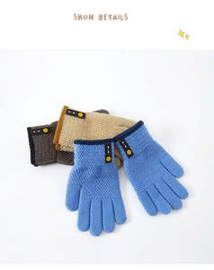 Close-up of knit winter gloves in blue and khaki with smiley face detail for children