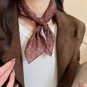 Detail of vintage paisley silk scarf styled as a stylish necklace accessory for women