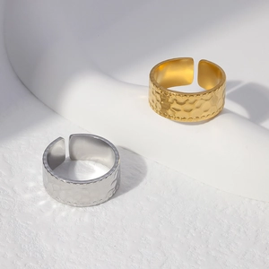 Detailed close-up of hammer-textured open rings in gold and silver finish