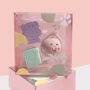 Detail view of cute bear and peach shaped makeup sponges in pink transparent gift box