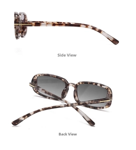 Detail of tortoise shell sunglasses with gold metal hinges and grey gradient lenses