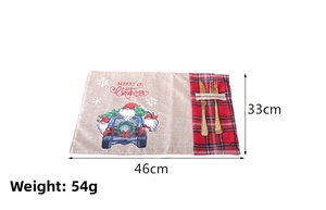 Detail of Christmas placemat with red plaid cutlery pocket and Santa truck print