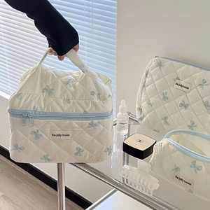 Quilted cotton makeup bag set with cute bow print and zipper closure in cream and blue