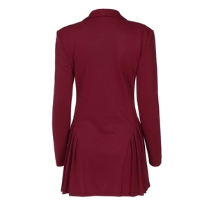 Detail view of the pleated back design on a burgundy long sleeve blazer dress