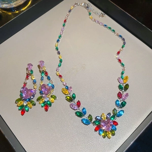 Detailed close-up of zircon necklace and earring set with colorful heart-shaped stones