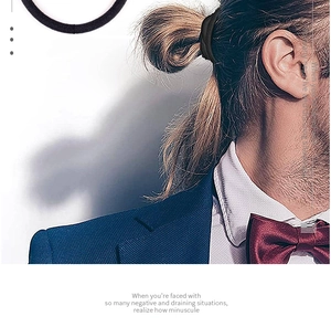 Detail shot of slim black elastic hair band worn by a model in formal business attire