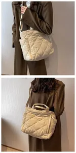 Detail of beige quilted cotton tote bag featuring large diamond stitching and soft texture