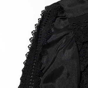 Detail showing the elegant black satin fabric and intricate lace embroidery of the dress