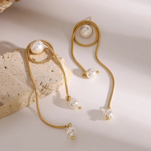 18k gold plated stainless steel pearl fringe earrings on a textured stone display