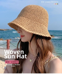 Straw sun hat worn by model at the beach showing wide brim and woven texture detail
