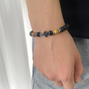 8mm natural tiger eye and black bead bracelet with silver cross pendant on wrist