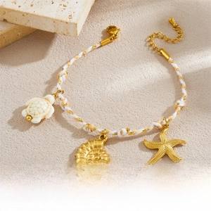 Detail of woven rope bracelet featuring sea turtle, starfish, and conch shell charms