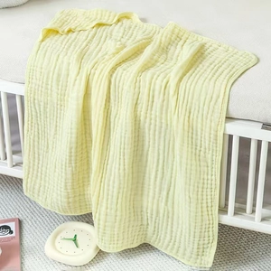 Detailed texture of 6-layer cotton muslin gauze hooded baby towel in soft yellow