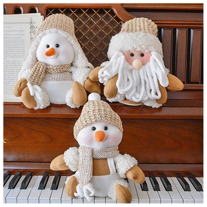 Detail of Christmas snowman and Santa plush dolls with knitted hats and scarves