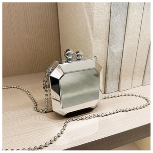 Macro shot of silver mirrored octagonal clutch featuring double sphere metal clasp and chain