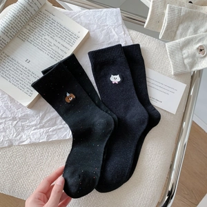 Detail of cotton crew socks featuring cute bear and cat embroidery in dark grey and black
