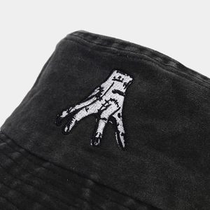 Washed black cotton bucket hat featuring a white hand embroidery in a vintage style