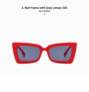 Front view of bold oversized red cat-eye sunglasses with dark grey smoke lenses
