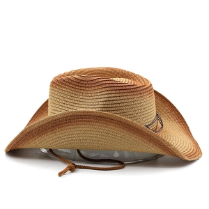 Detail of woven straw cowboy hat featuring brown gradient texture and adjustable chin strap