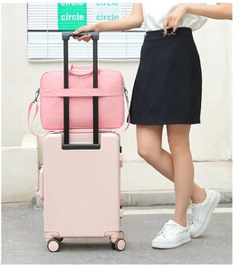 Pink laptop bag with luggage strap fixed on pink suitcase for travel scenario