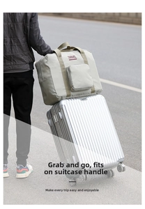 Gray oxford travel bag with sleeve attached to a suitcase handle for easy carrying