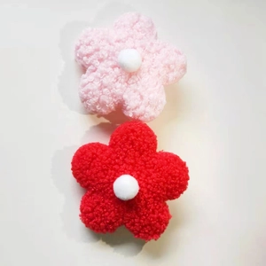 Detail of 8cm plush teddy velvet flower accessories in soft pink and vibrant red colors
