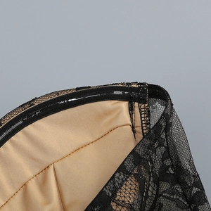 Close-up of black lace dress bodice showing non-slip silicone strip and nude lining