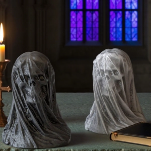 Detailed texture of veiled skull gothic resin mold art statue with candle light