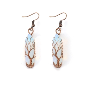 Detail of handmade wire wrapped tree of life earrings with opal hexagonal crystal stones