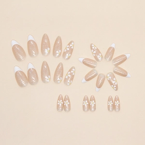 Almond press-on nails with white French tips, daisy floral patterns and gold glitter finish