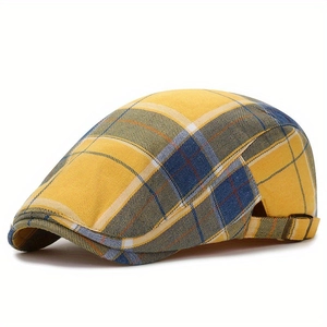 Classic yellow plaid newsboy cap with vintage metal buckle on a clean white background