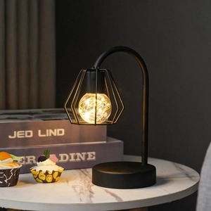 Close-up of geometric iron wire lamp with warm LED starry copper string light bulb