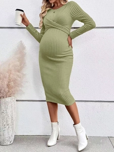 Close-up of the ribbed knit fabric and twisted knot detail on the sage green maternity dress