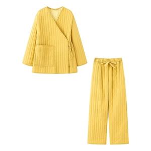 Detailed view of yellow quilted loungewear set with V-neck tie-up top and straight pants