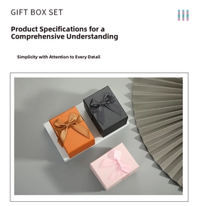 Detailed view of square gift box set with velvet ribbon bows in orange black and pink