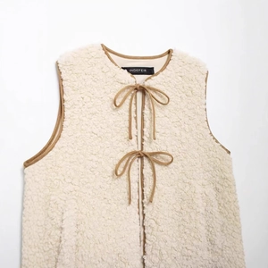 Chic cream fleece vest with brown contrast piping and double bow tie closures