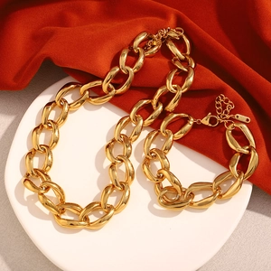 Detail of 18K gold plated chunky chain necklace and bracelet with K18 hallmark on silk