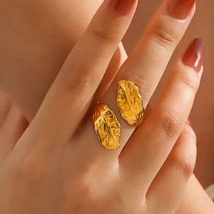 Polished gold feather open ring with adjustable band and intricate leaf textures