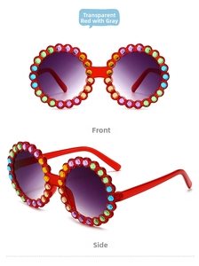 Detail of round kids sunglasses with transparent red frame and colorful rhinestones