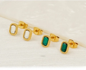 Macro shot of rectangular vintage stud earrings in emerald and clear stainless steel