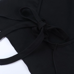 Close-up of elegant black halter neck knit top featuring a delicate ribbon bow tie detail