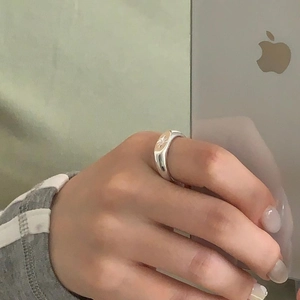 Detailed mirror view of a 925 sterling silver starburst signet ring worn on a finger