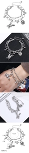 Detail view of double-layer stainless steel bracelet with rabbit and love pendants
