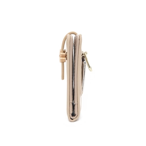 Detail of flower shaped buckle and zipper on beige PU leather compact wallet for women