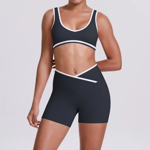 Detail of high-waist yoga set with V-shaped crossover shorts and white contrast piping