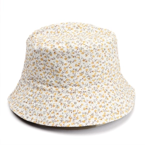 Detail shot of a double-sided sun hat featuring a vibrant green and yellow floral pattern