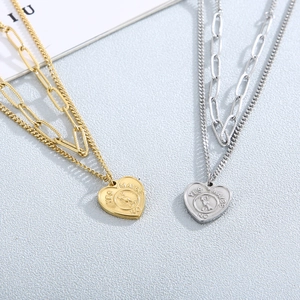 Minimalist double layer heart pendant necklace in gold and silver stainless steel finish