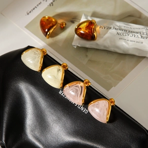 Triangle resin stud earrings with amber and cream patterns in a gold stainless steel frame