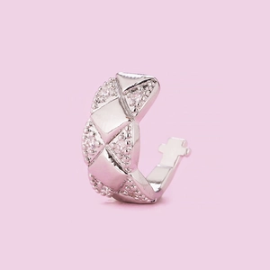 Detailed view of silver quilted ear cuff with micro-paved cubic zirconia stones