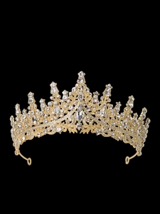 Detailed view of luxury gold princess crown with sparkling crystals on black background